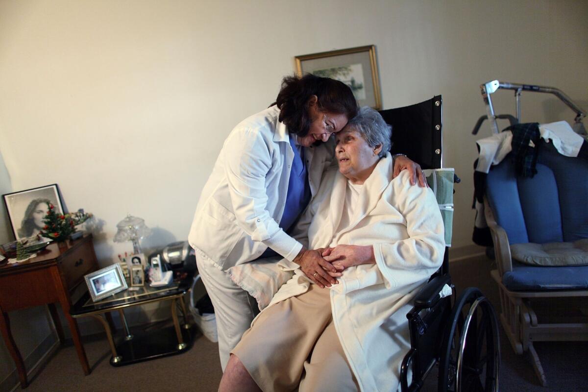 The Labor Department on Tuesday announced a rule to extend minimum wage and overtime protections to nearly 2 million direct care workers, including home health aides. Above, a home health aide working with a patient in Florida in 2010.