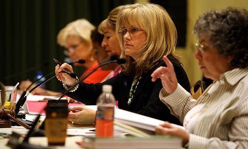 Susanne Phillips, center, participates in a meeting of the California Board of Registered Nursing, which she serves as president.