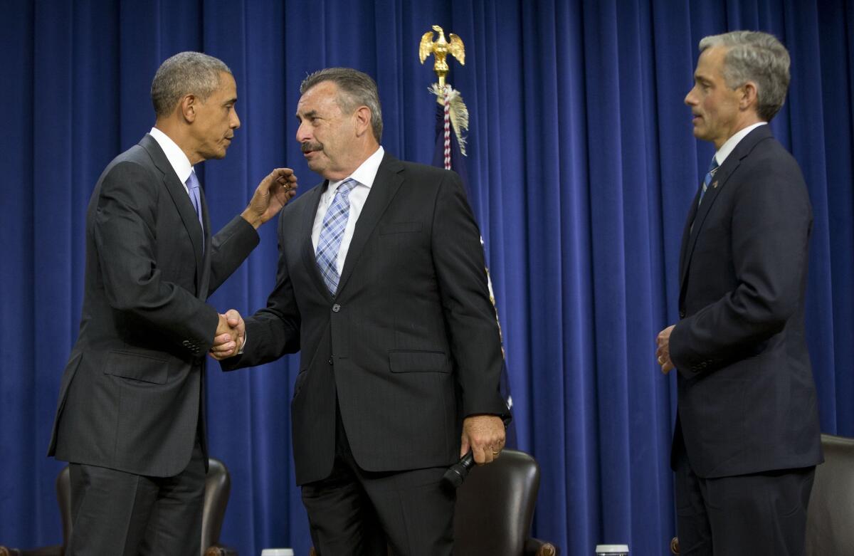President Obama shakes hands with Los Angeles Police Chief Charlie Beck during a forum on criminal justice reform last week in Washington. At right is John Walsh, U.S. attorney for the District of Colorado.