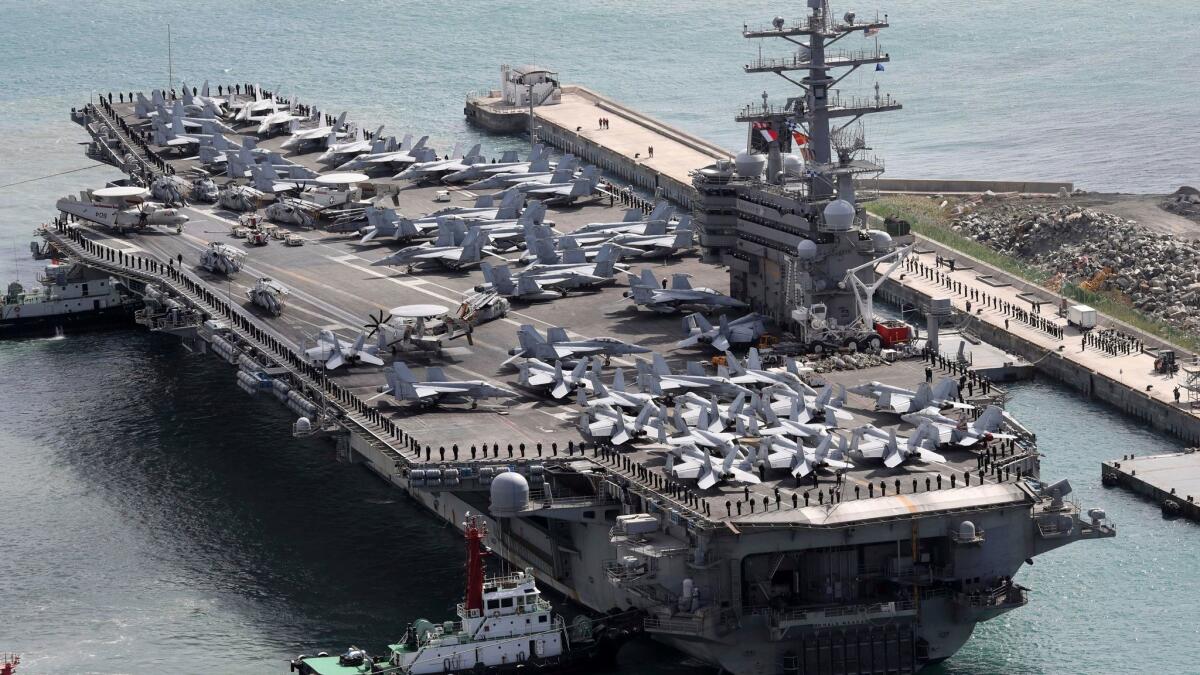 The aircraft carrier Ronald Reagan is escorted Oct. 21 into the Busan port in South Korea.