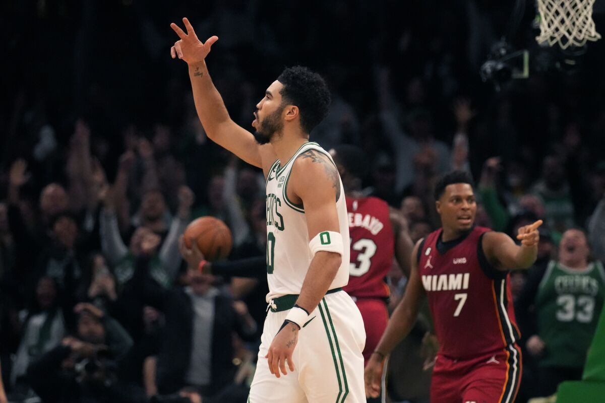 Boston Celtics forward Jayson Tatum (0) celebrates after hitting a 3-pointer during the second half of the team's NBA basketball game against the Miami Heat, Wednesday, Nov. 30, 2022, in Boston. (AP Photo/Charles Krupa)