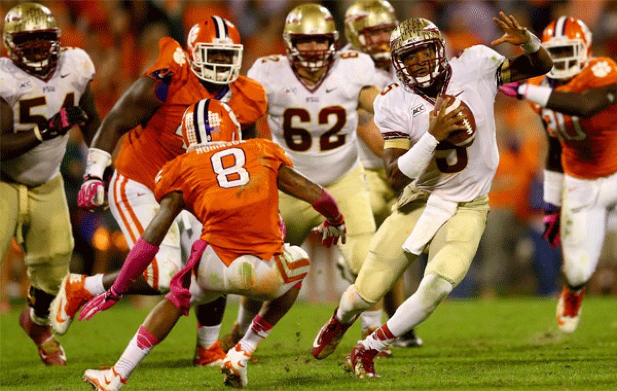 Florida State quarterback Jameis Winston runs with the ball against Clemson's Darius Robinson at Memorial Stadium on Saturday.
