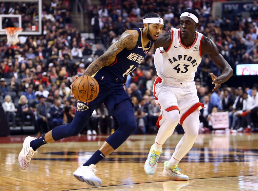 Pelicans forward Brandon Ingram drives past Raptors forward Pascal Siakam during the first half of a game on Oct. 22, 2019, in Toronto.