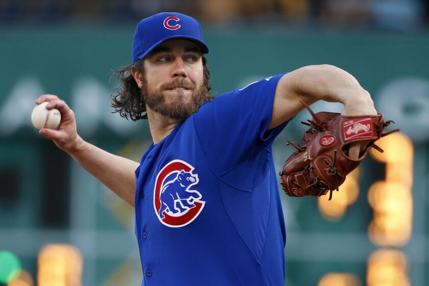 Cubs starting pitcher Dan Haren warms up before the first inning.