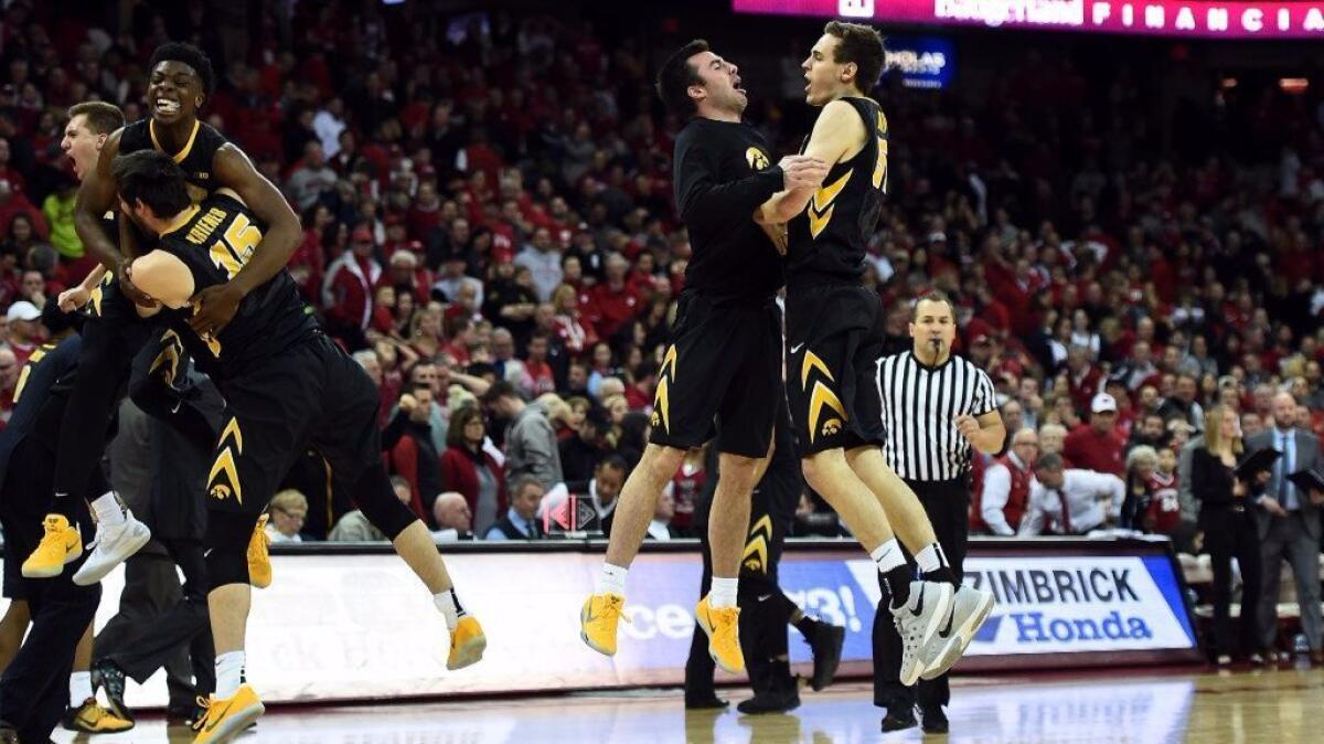 Members of the Iowa Hawkeyes celebrate a victory over Wisconsin at the Kohl Center on Mar. 2 in Madison, Wisconsin.