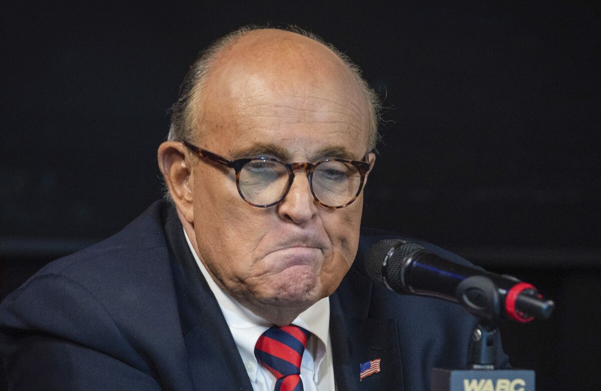 FILE - Former New York City Mayor Rudy Giuliani reacts during a talk radio show at the WABC studios in New York on Friday, Sept. 10, 2021. A judge overseeing a review of electronic devices seized from Giuliani said that he and his lawyers have only sought to shield three items among more than 2,200 items reviewed. (AP Photo/Robert Bumsted, File)