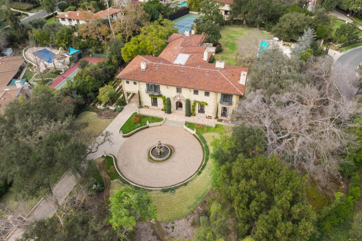 Aerial view of the mansion, its circular motor court and surrounding trees.