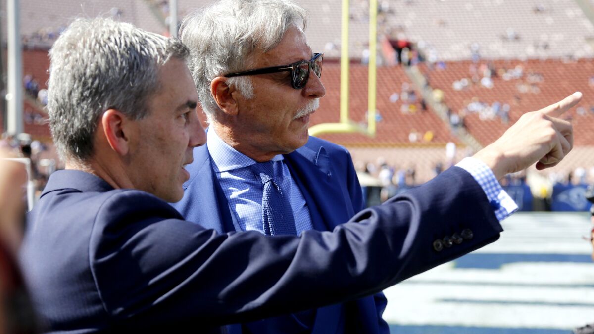 Rams executive Kevin Demoff, left, talks to owner Stan Kroenke before a preseason game at the Coliseum on Aug. 13.