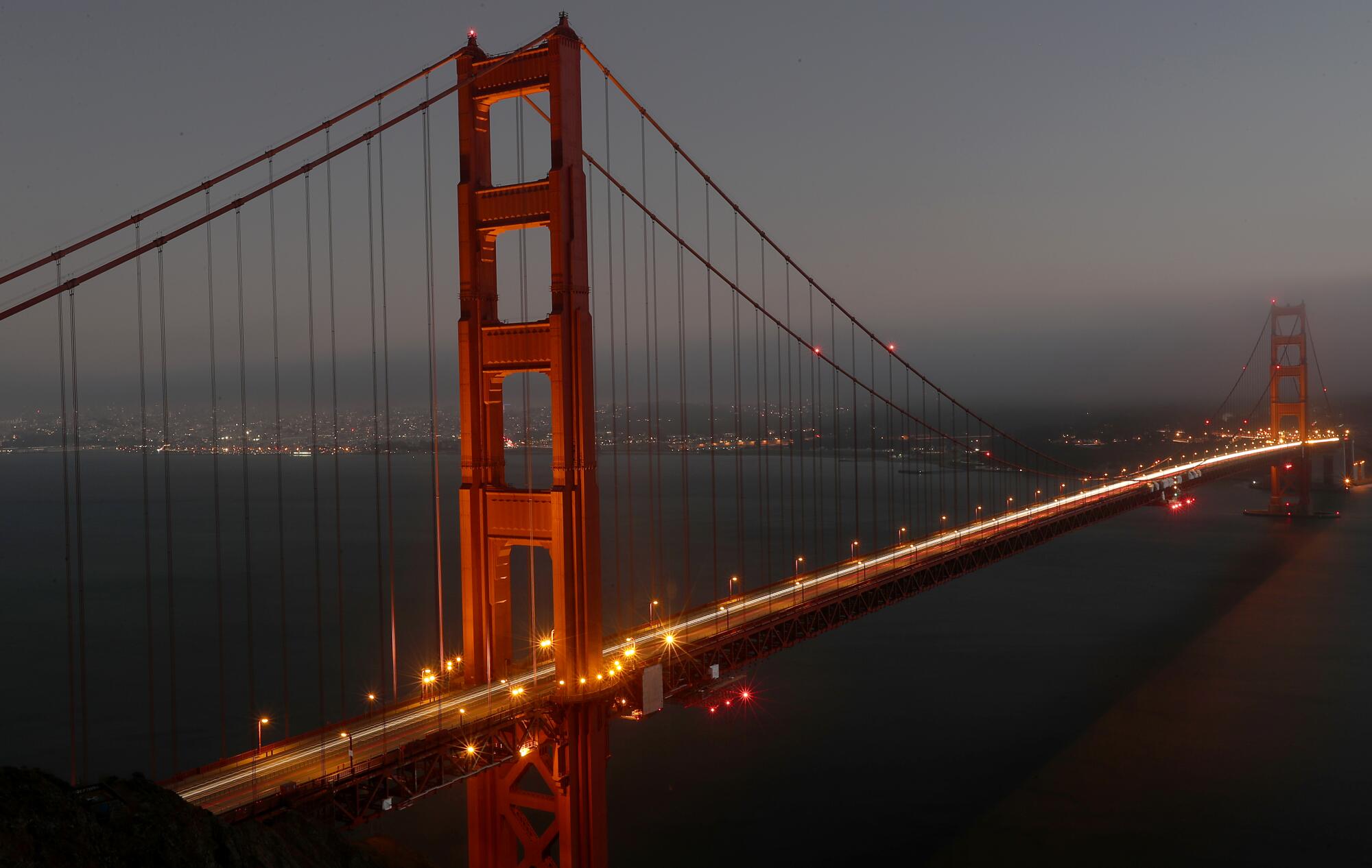 Automobile headlights trace streaks of white across the Golden Gate Bridge in San Francisco.