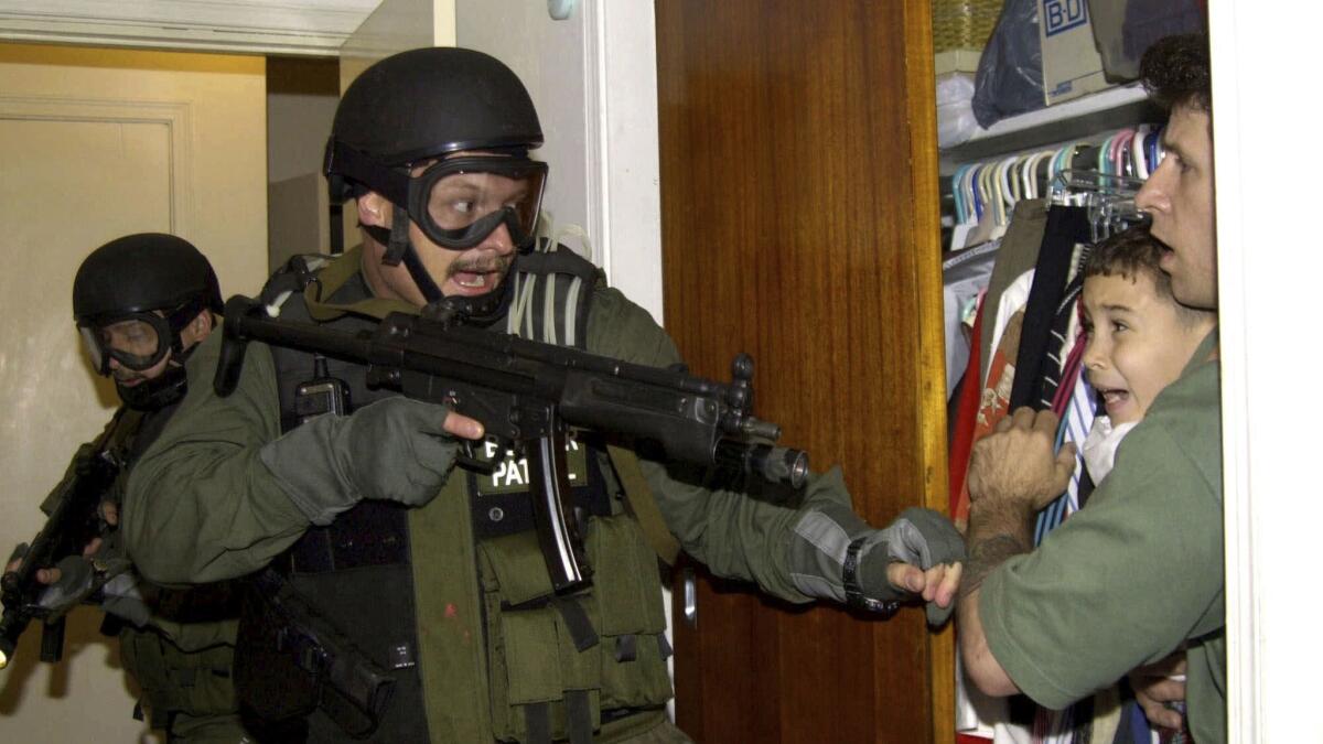 This image of a frightened Elian Gonzalez being held as federal agents raided his relatives' Miami home earned Alan Diaz a Pulitzer prize.
