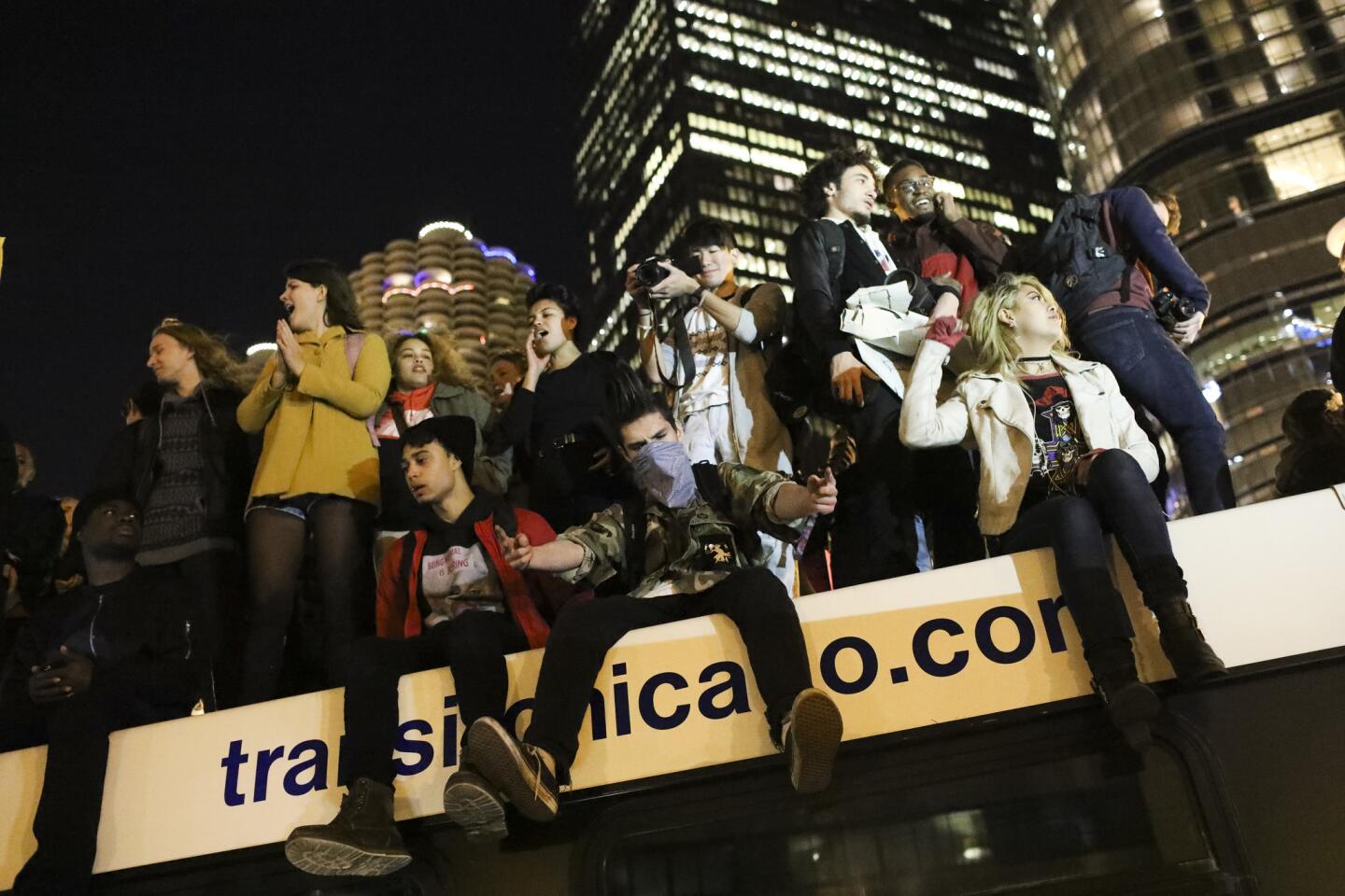 Protesters stand on a bus near the intersection of North Wabash Avenue and East Upper Wacker Drive while marching on Nov. 9, 2016, the day after Donald Trump won the presidential election.