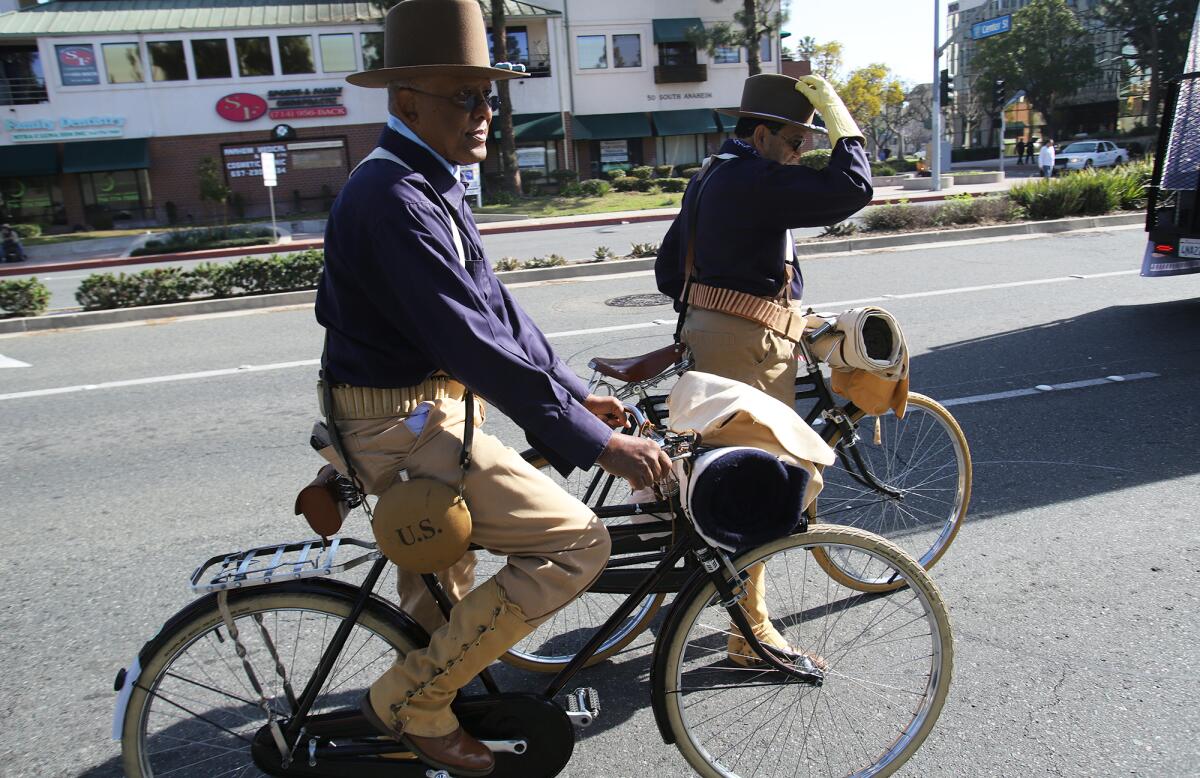 Trooper Ron R. Jones and Trooper Robert V. McDonald ride bicycles as the Buffalo Soldiers.
