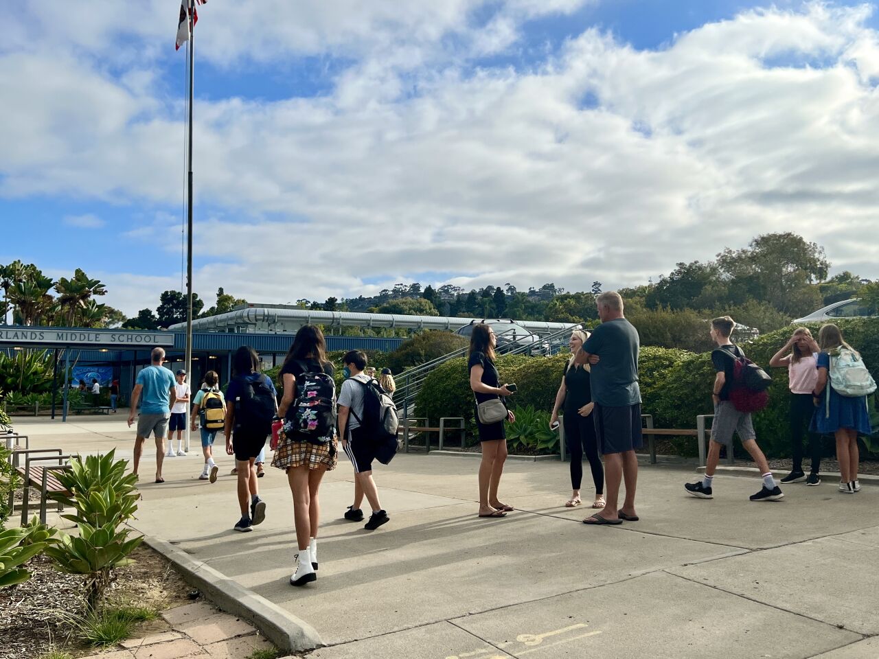 Parents gather as students stroll onto campus at Muirlands Middle School in La Jolla for the first day of the 2022-23 school year.