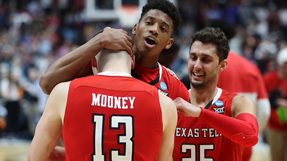 Texas Tech's Jarrett Culver, Matt Mooney and Davide Moretti (25) celebrates after securing the Red Raiders' first trip to the Final Four.