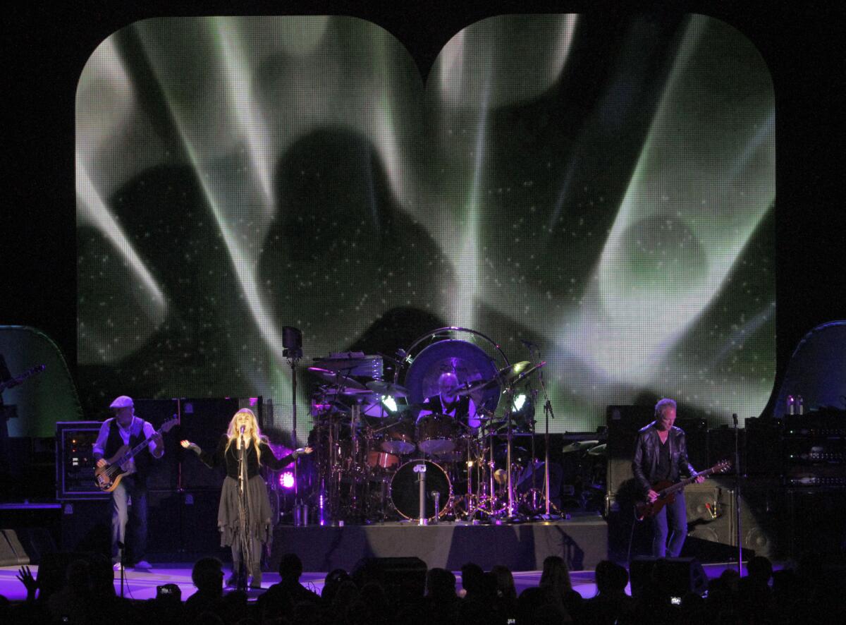 Fleetwood Mac's John McVie, left, Stevie Nicks, Mick Fleetwood and Lindsey Buckingham perform at the Hollywood Bowl on May 25, 2013. The band will return to a familiar venue -- the Forum -- on a familiar date -- Dec. 6.