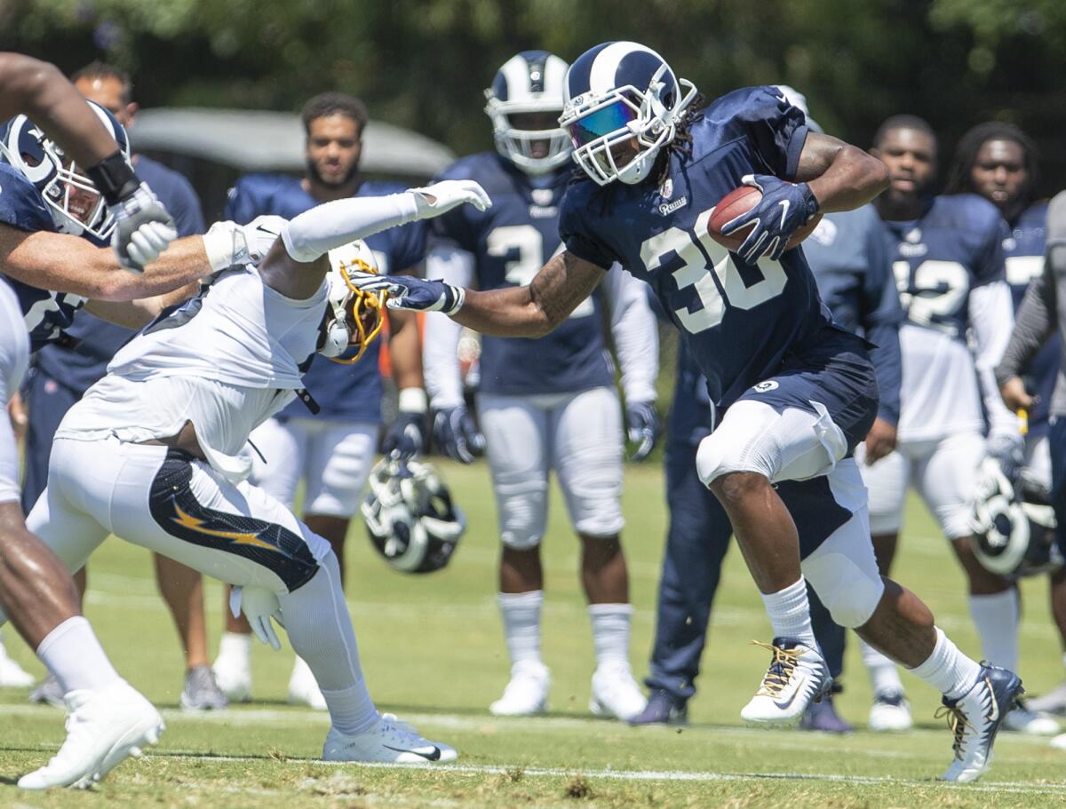 Los Angeles Rams' Todd Gurley runs the ball during a joint practice with the Los Angeles Chargers on Thursday at Jack R. Hammett Sports Complex in Costa Mesa.