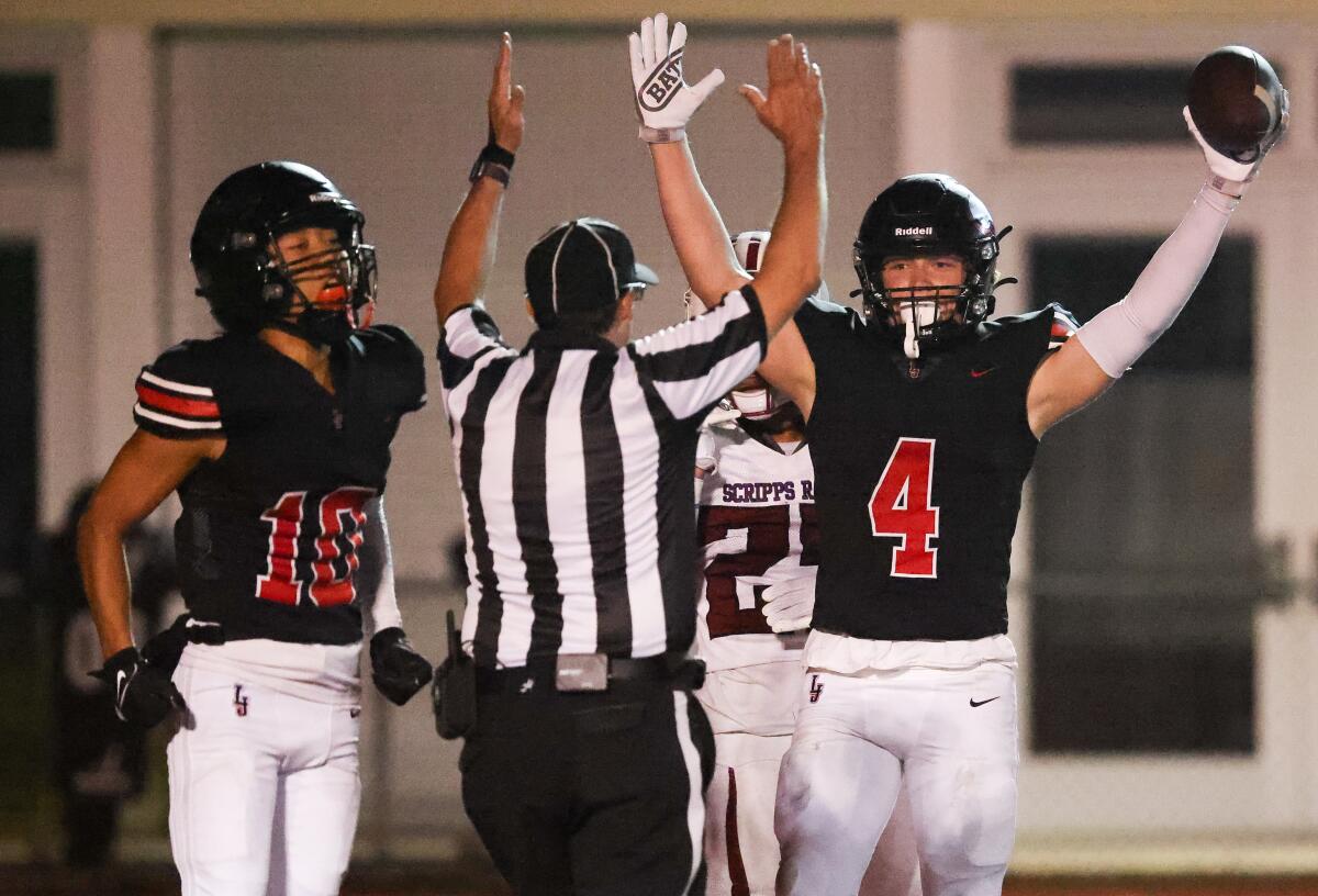 La Jolla High School's Hank Hansen (4) celebrates a touchdown against Scripps Ranch on Aug. 25.