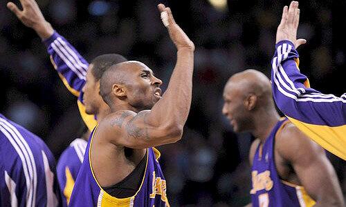 Guard Kobe Bryant and his Lakers teammates celebrate their 110-109 overtime victory at Boston on Thursday night.