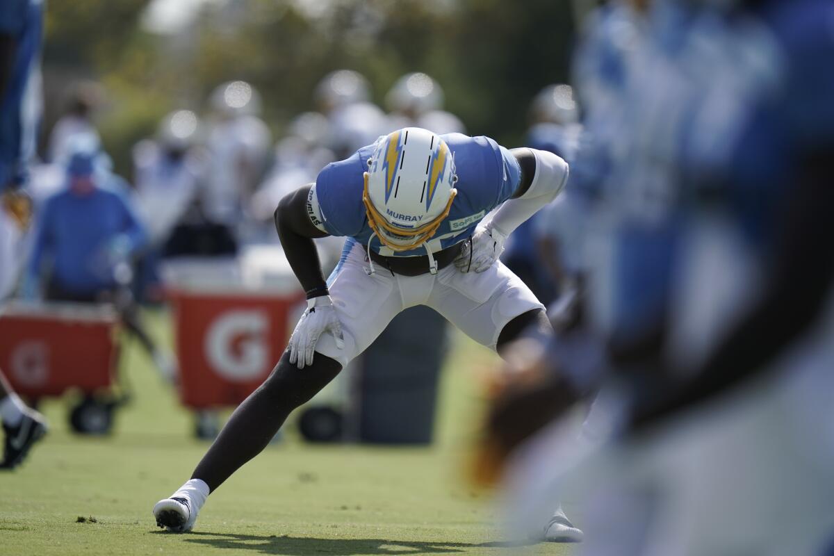 Los Angeles Chargers linebacker Kenneth Murray stretches during practice