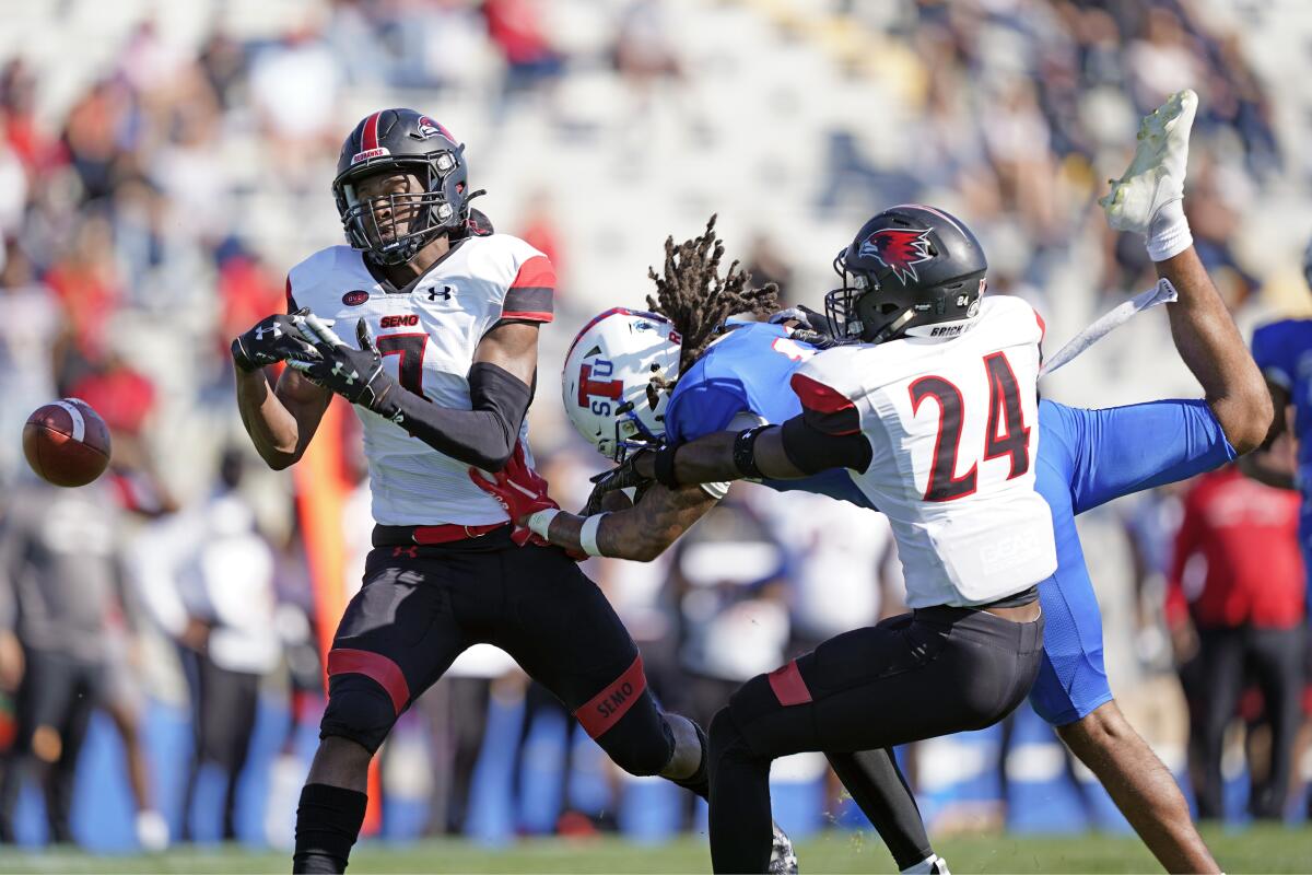 Southeast Missouri State defenders Lawrence Johnson (7) and Shabari Davis (24) break up a pass intended for Tennessee State wide receiver Zaire Thornton during an NCAA college football game Sunday, April 11, 2021, in Nashville, Tenn. Because of COVID-19, the OVC postponed the 2020 season to the spring, and the decision was made to play games on Sunday because member schools needed flexibility to staff all the spring sports. (AP Photo/Mark Humphrey)