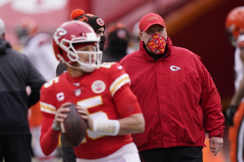 Chiefs coach Andy Reid, right, watches quarterback Patrick Mahomes warm up.