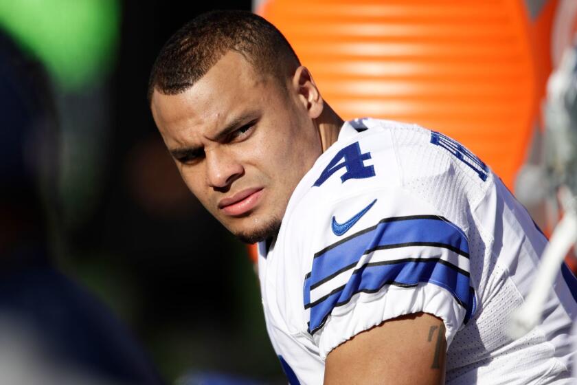 Dallas quarterback Dak Prescott watches from the bench during a game against Philadelphia on Jan. 1.