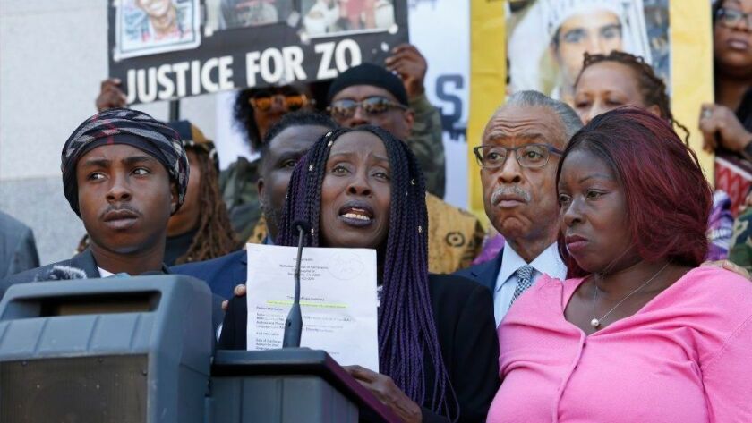 Sequitta Thompson, center, is joined by family and activists in calling for justice for her grandson Stephon Clark at a news conference this year in Sacramento about the deadly police shooting.