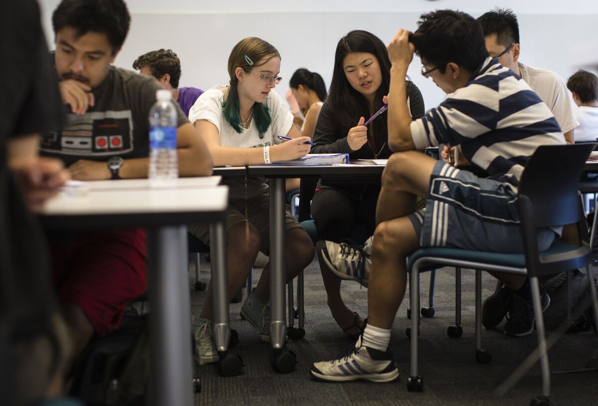 Students Nicole Kyle, Jessica Iwamoto, Daniel Nguyen and Yeahmoon Hong, right, work in a group to problem solve during a chemical and thermal processes class at Harvey Mudd College in Claremont.