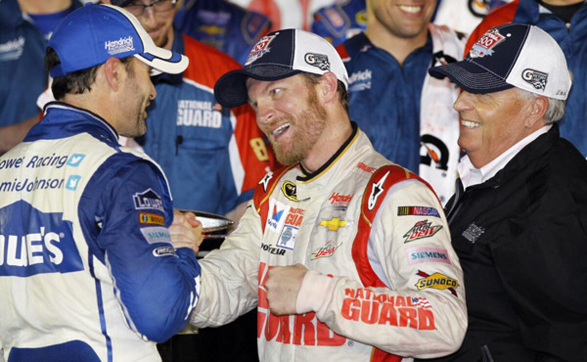 Dale Earnhardt Jr., center, celebrates in victory lane with teammate Jimmie Johnson, left, and team owner Rick Hendrick after winning the Daytona 500 on Sunday night.