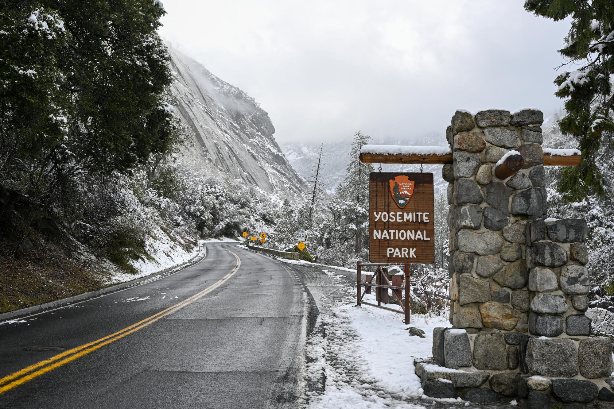 A welcome sign is seen as snow blankets Yosemite National Park, which remains closed until March 1.