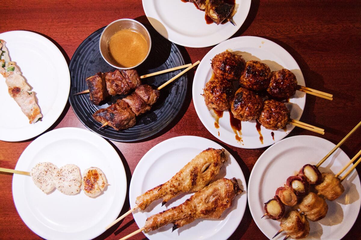 An overhead photo of an array of yakitori, or meat cooked on skewers.