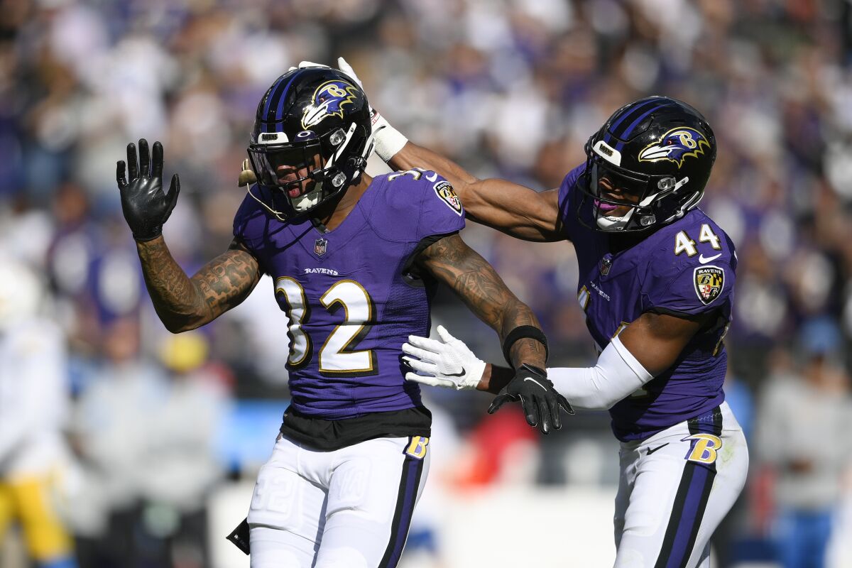 Baltimore Ravens free safety DeShon Elliott (32) and cornerback Marlon Humphrey (44) react after breaking up a pass from Los Angeles Chargers quarterback Justin Herbert, not visible, during the second half of an NFL football game, Sunday, Oct. 17, 2021, in Baltimore. (AP Photo/Nick Wass)