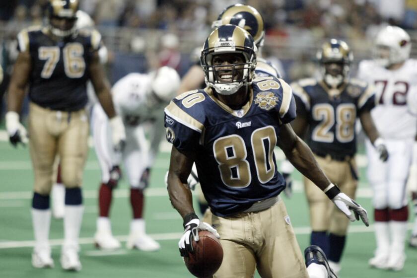 Rams receiver Isaac Bruce scores a touchdown against the Arizona Cardinals in St. Louis on Sept. 12, 2004.