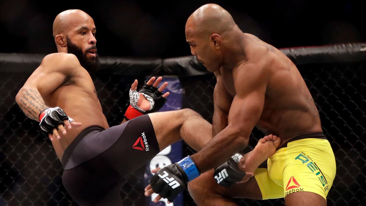 Demetrious Johnson lands a kick against Wilson Reis during their UFC flyweight title fight on Saturday night at Sprint Center.