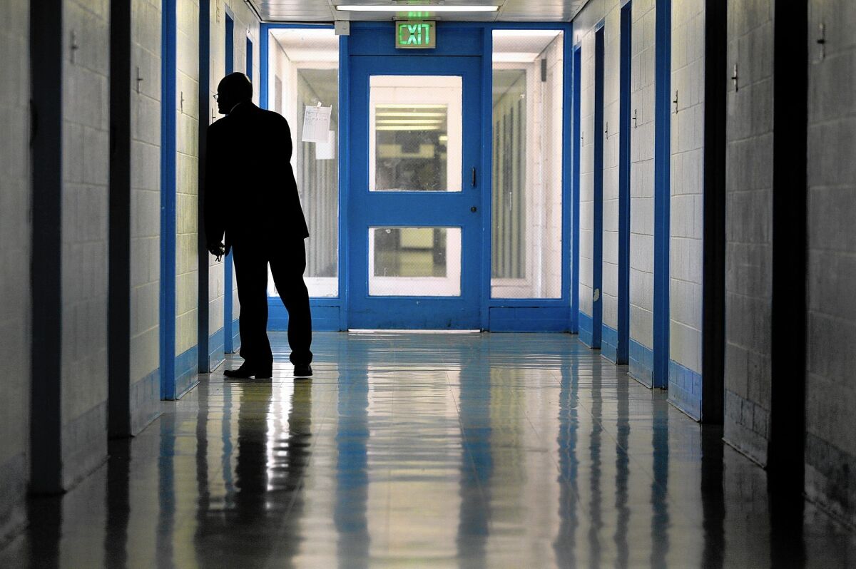 Supt. Gregory McCovey peers inside a room at Central Juvenile Hall in Los Angeles in 2014.