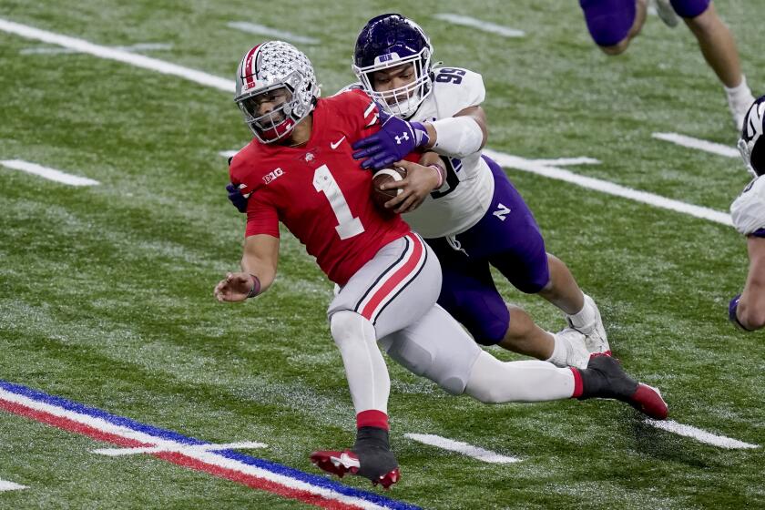 Northwestern defensive end Earnest Brown tackles Ohio State's Justin Fields in the Big Ten title game Dec. 19, 2020.