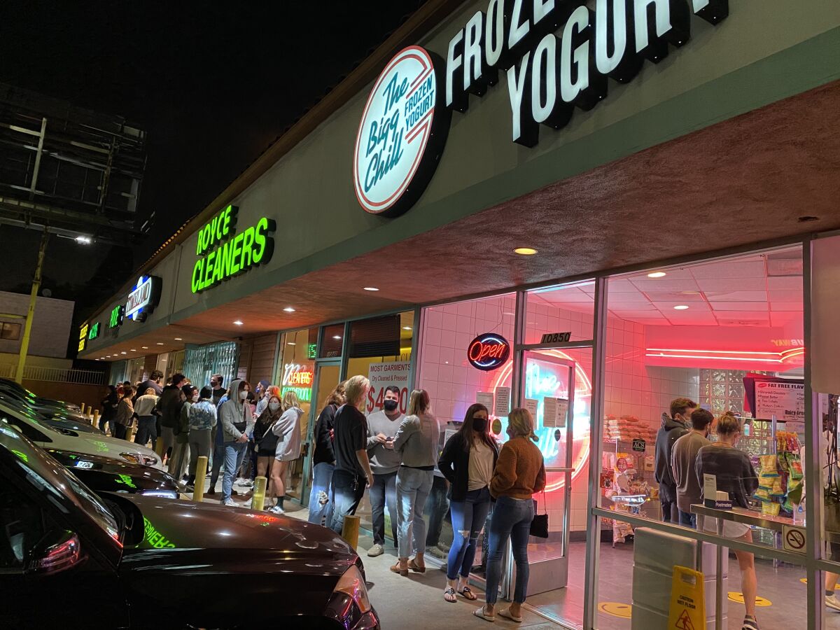 A long line of customers on the sidewalk outside the Bigg Chill frozen yogurt shop