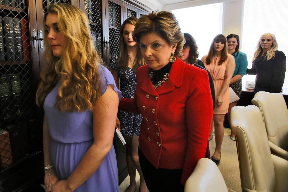 Attorney Gloria Allred, right, escorts six current or former Occidental College students after filing a civil rights complaint outlining alleged violations of Title IX, which bars sex discrimination at schools.