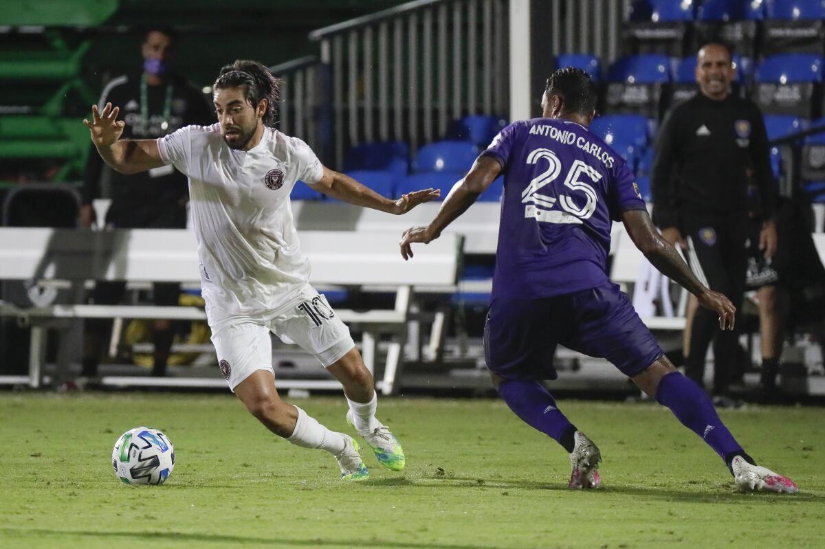 Inter Miami's Rodolfo Pizarro moves the ball past Orlando City's Antonio Carlos during the second half in Kissimmee, Fla.