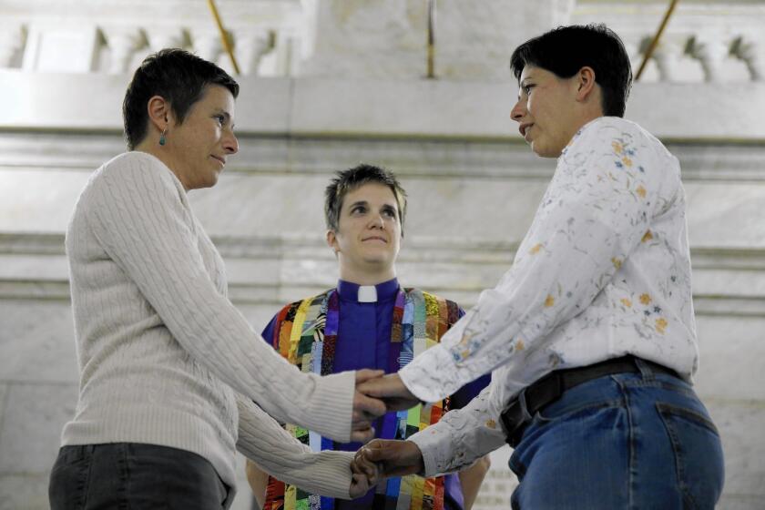 A couple marries in November in St. Louis. Some Missouri counties are issuing same-sex marriage licenses while the state's ban is being challenged.