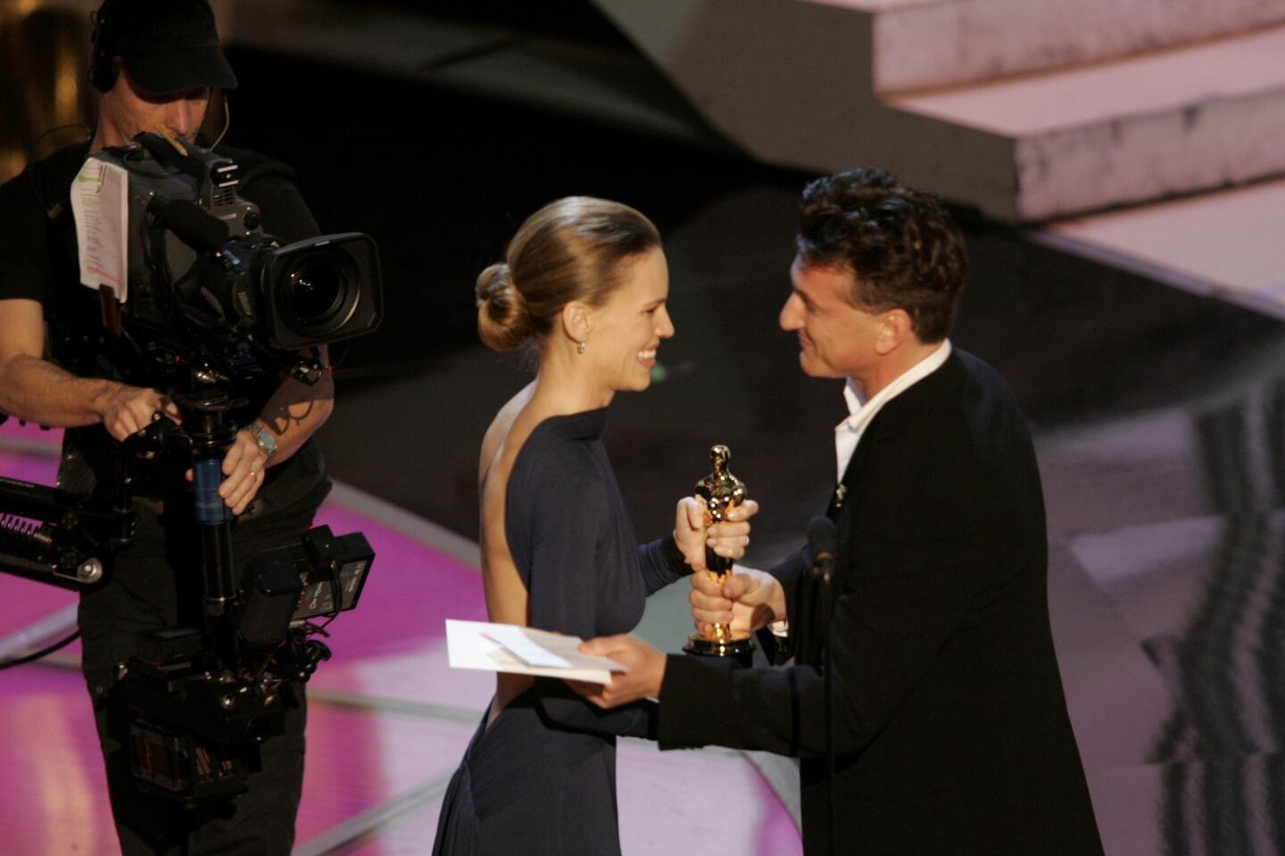 The 77th Academy Awards assigned stand-up comedian Chris Rock to the hosting post, foreshadowing a night of ruder-than-usual digs at celebrities for laughs. Take this for example: "Who is Jude Law?" Perhaps actor Sean Penn thought that Law forgot his armor, stepping onstage to defend his peer.