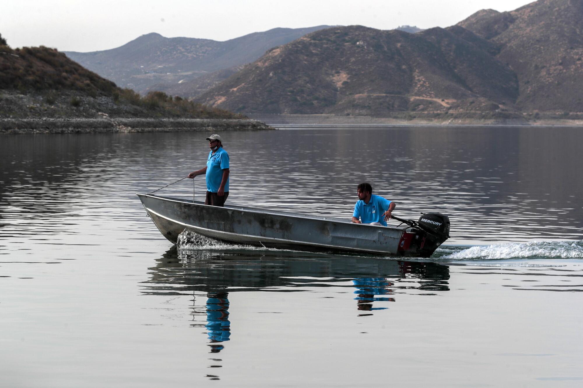 Two people in a boat on a lake.