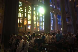 Worshippers attend a Mass in the Sagrada Familia basilica in Barcelona, Spain, Sunday, July 9, 2023. With tourism reaching or surpassing pre-pandemic levels across Southern Europe this summer, iconic sacred sites struggle to find ways to accommodate both the faithful who come to pray and millions of increasingly secular visitors attracted by art and architecture. (AP Photo/Emilio Morenatti)