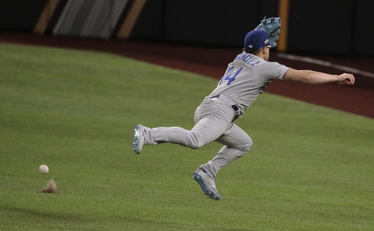 A run-scoring single by Ozzie Albies bounces past Dodgers second baseman Kiké Hernández.