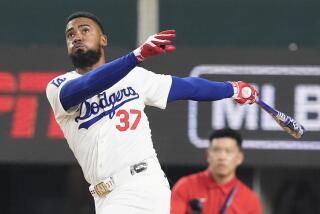 Dodgers outfielder Teoscar Hernandez follows through on a swing during the MLB Home Run Derby at Globe Life Field.