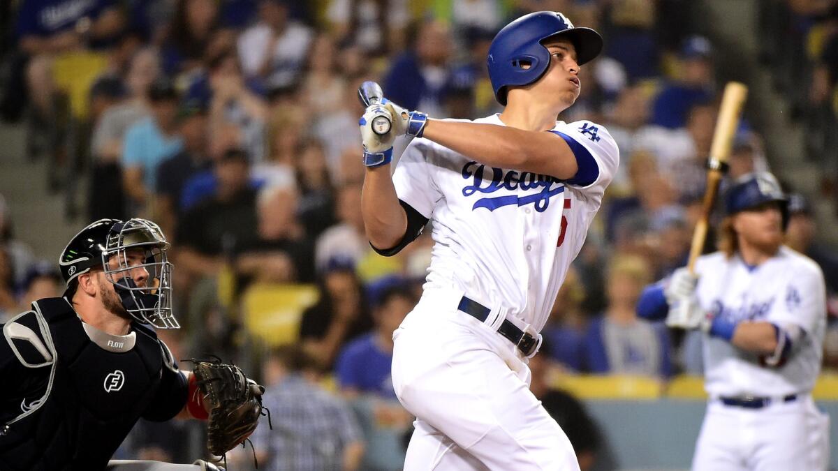 Dodgers shortstop Corey Seager follows through on the second of his three homers Friday night.