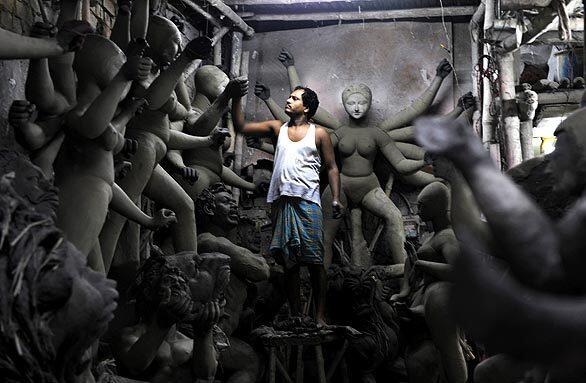 An Indian idol maker works on a clay statue of Hindu goddess Durga in Kumartuli, the idol makers village, in Kolkata. The global economic meltdown has hit idol makers, as export orders from expatriate Indians belonging to the Bengali community has declined, according to local reports.