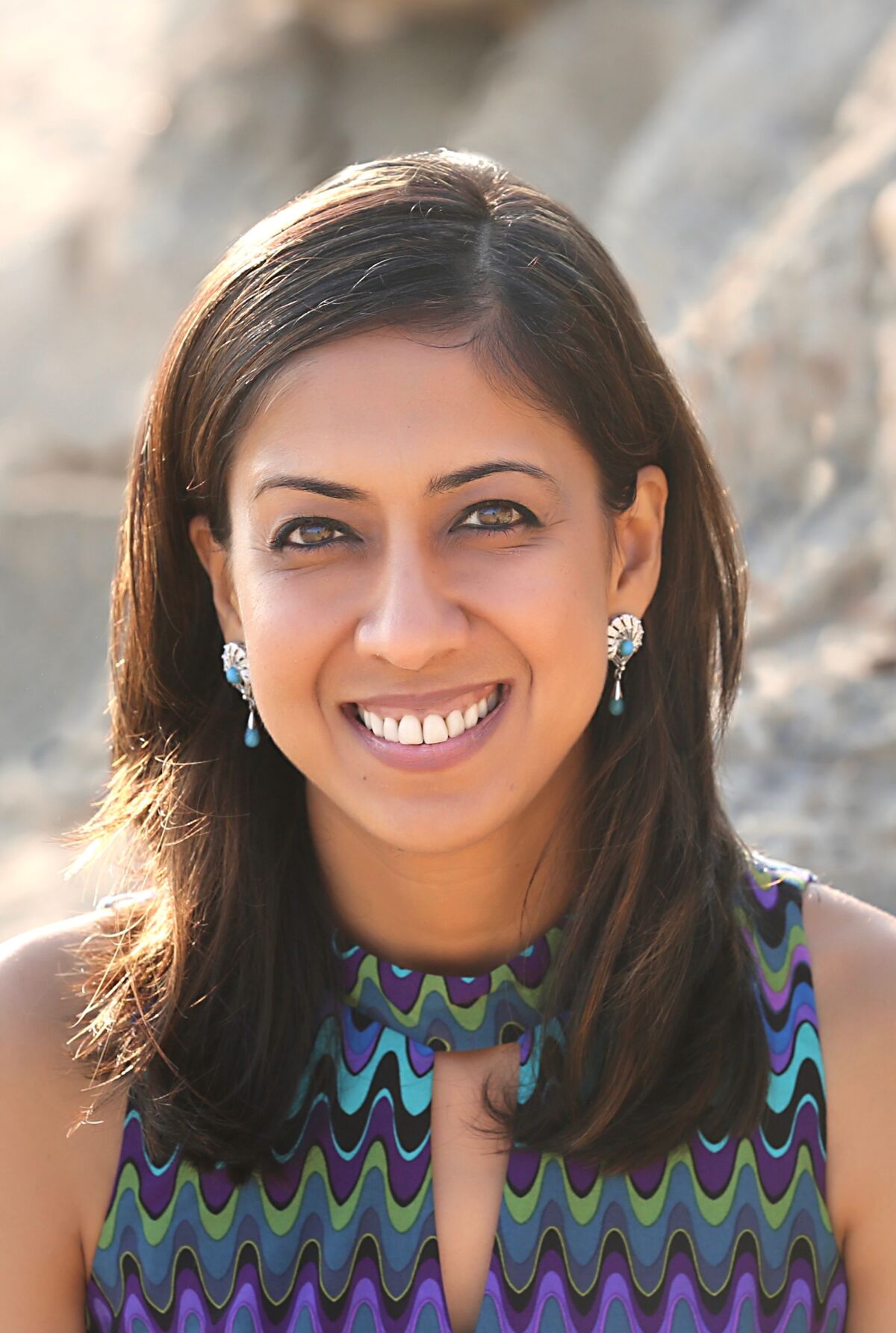 A headshot of a woman outside