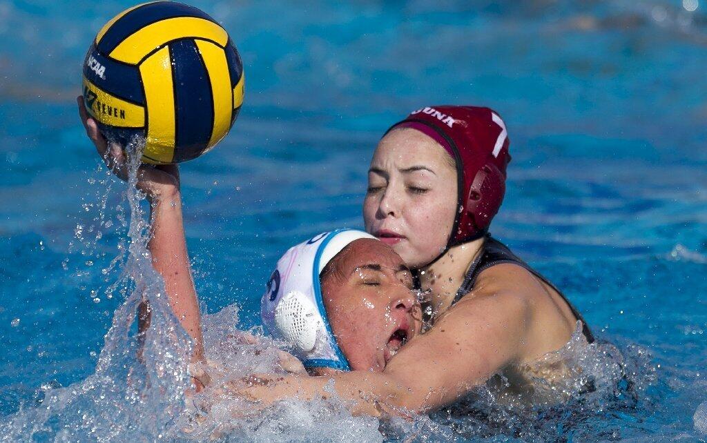 Corona del Mar High's Marina Coskinas gets tangled up with Laguna Beach's Taylor Julson during a semifinal match of the Holiday Cup on Saturday.