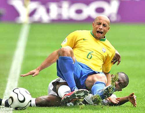 Brazilian defender Roberto Carlos is tackled by Ghana's forward Matthew Amoah in the second round of the World Cup.
